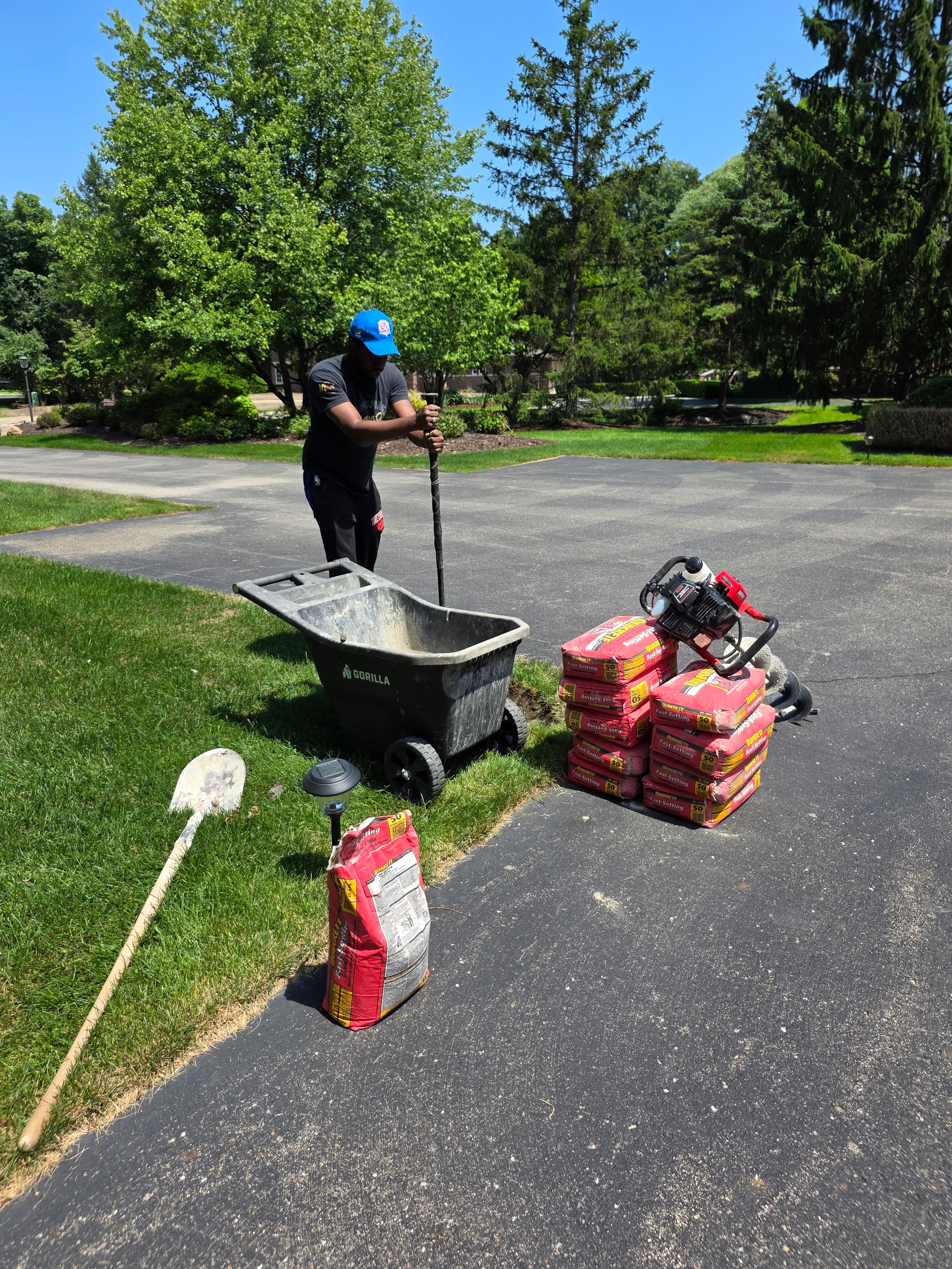 In-ground basketball hoop being installed